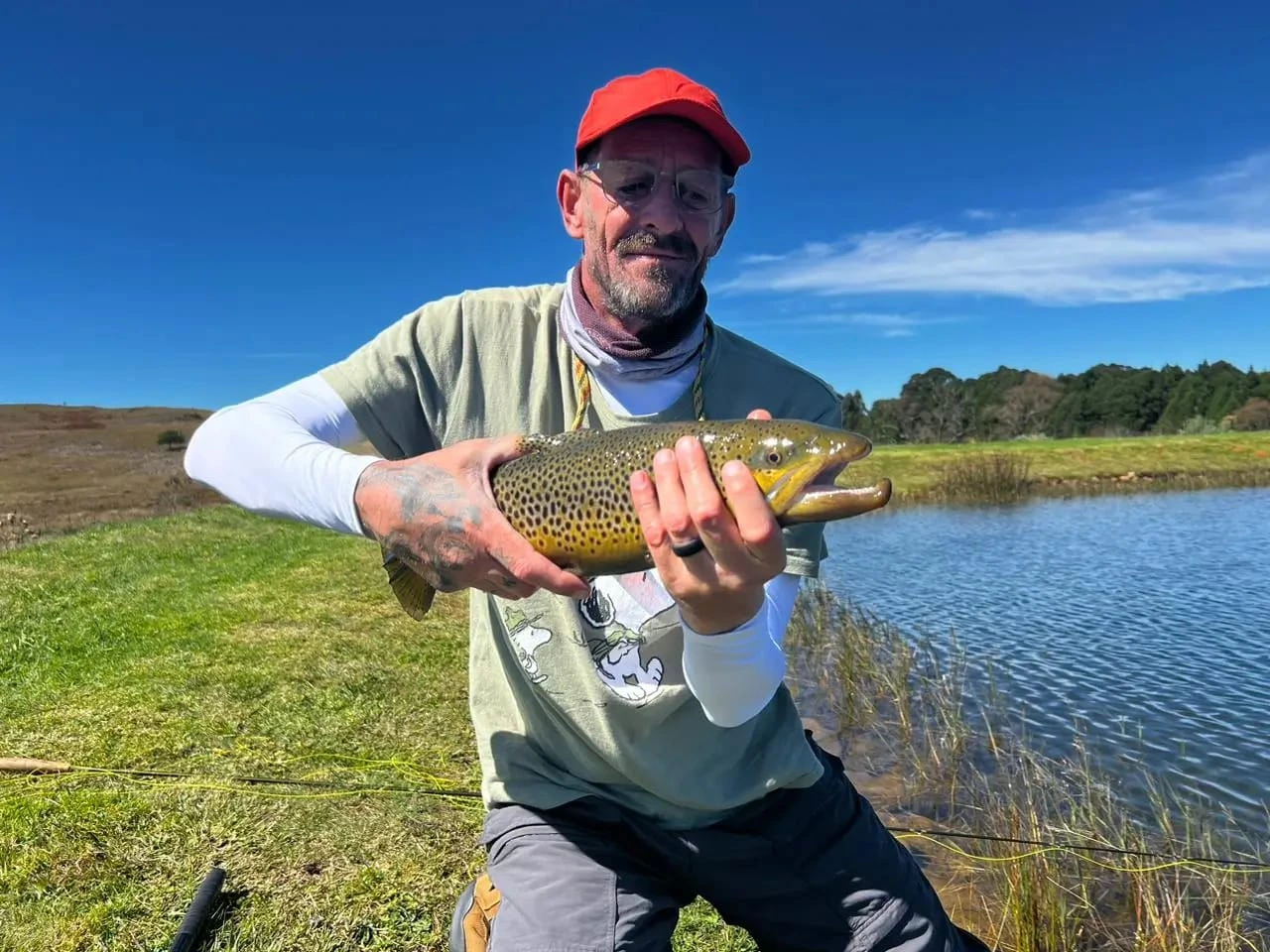 Guide and angler at a Dullstroom stillwater holding a brown trout